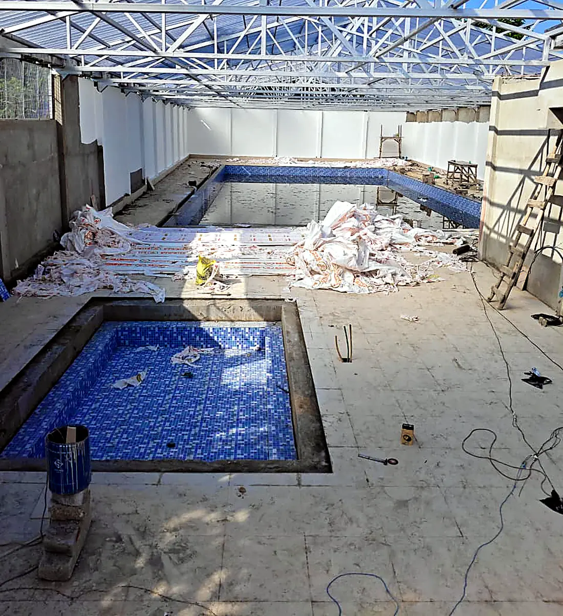 Indoor half-Olympic-size swimming pool and baby pool under construction at Mount Litera Zee School, Islampur